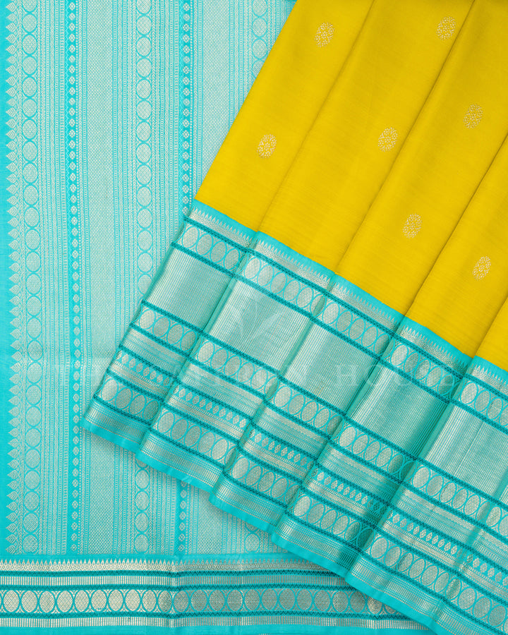 Yellow Kanchivaram Silk Saree with Silver Zari Butis & Turquoise Contrast Border