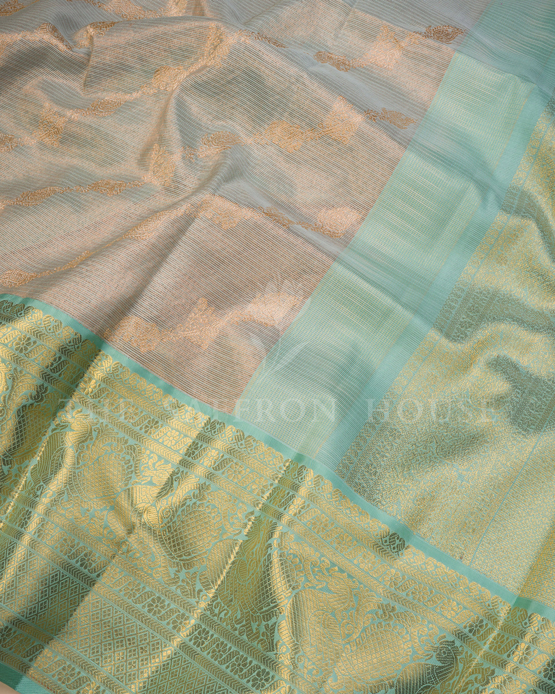 Sea Green Kanchivaram Silk Saree with Diagonal Gold Zari Weave & Peacock Motif Border