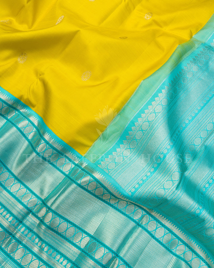 Yellow Kanchivaram Silk Saree with Silver Zari Butis & Turquoise Contrast Border